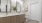 Large well lit bathroom with brown cabinents