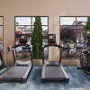 Room with workout equipment and windows