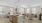 Large well lit kitchen with wood floors and stainless steel appliances.