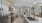 Large well lit kitchen with wood floors and stainless steel appliances.