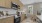 Large well lit kitchen with wood floors and stainless steel appliances.