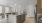 Large well lit kitchen with wood floors and stainless steel appliances.