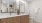 Large well lit bathroom with brown cabinets