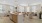 Large well lit kitchen with wood floors and stainless steel appliances.