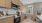 Large well lit kitchen with wood floors and stainless steel appliances.