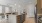 Large well lit kitchen with wood floors and stainless steel appliances.